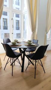 a table with chairs and plates and glasses on it at Le Cocon Studio in Brussels