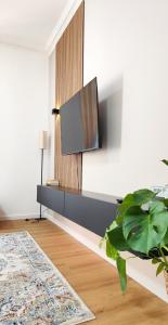 a living room with a flat screen tv on a wall at Le Cocon Studio in Brussels
