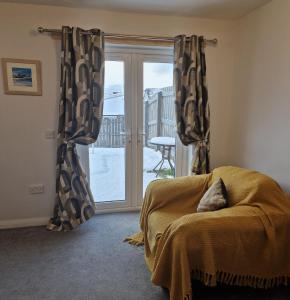 a bedroom with a bed and a sliding glass door at Faillie in Inverness