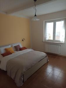 a bedroom with a large bed and a window at Isangarda Apartment in Candelo