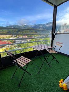 ゲンティンハイランドにあるCamp in Style with Indoor Balcony Adventures at Gentingの景色を望むバルコニー(テーブル、椅子2脚付)