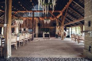 a barn wedding with tables and chairs and chandeliers at Kawalerski, Impreza, Wesele in Miechowice Wielkie