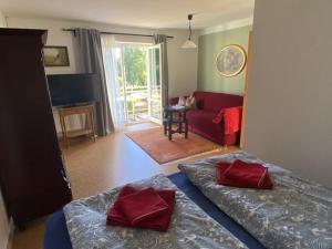 a bedroom with two beds and a living room at Ferienwohnung Kirchbergaussicht in Olbersdorf