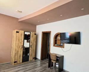 a room with a tv and a table with a chair at Trip Inn Budget Hotel Messe in Frankfurt/Main