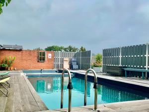 a swimming pool with two metal rails next to a building at Bahnhof Frauenstein SCHLOSSBLICK in Frauenstein