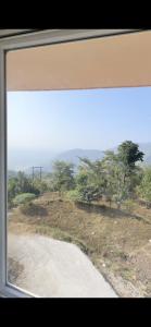 a view from a window of a dirt road at Hilltop hideaway in Kandogal