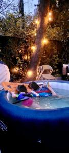 two people are laying in a swimming pool at The Wooden House, Spacious, garden, new and modern in Oslo