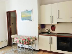 a small kitchen with a table and a sink at Monolocale centrale in Alassio