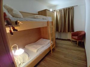 a room with two bunk beds and a desk at la fonte in Sporminore