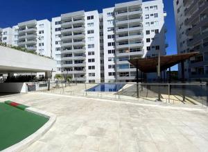 a swimming pool in front of some tall buildings at 3BRR Apto luxury en palmetto 402 in Valledupar