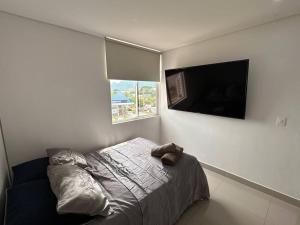 a bedroom with a bed with a teddy bear on it at 3BRR Apto luxury en palmetto 402 in Valledupar