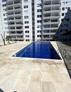 a swimming pool in front of some tall buildings at 3BRR Apto luxury en palmetto 402 in Valledupar