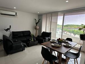a living room with a table and leather furniture at 3BRR Apto luxury en palmetto 402 in Valledupar