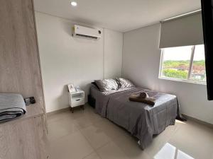 a small bedroom with a bed and a window at 3BRR Apto luxury en palmetto 402 in Valledupar +49 photos