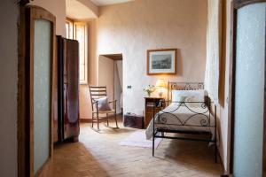 a bedroom with a bed and a table and a chair at Il Castello di San Michele in San Michele in Teverina
