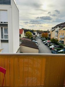 a balcony with a view of a parking lot with cars at Chambre spacieuse in Montmagny