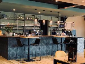 a bar with bar stools in a restaurant at Het Wapen van Aelden in Aalden