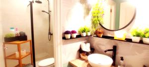 a bathroom with a sink and a toilet and plants at JARAUTARESORT in Pamplona +43 photos