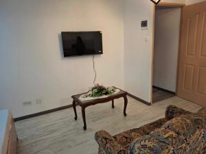 a living room with a couch and a coffee table at Ant's residence in Curepipe