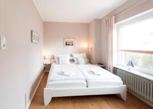 Ένα ή περισσότερα κρεβάτια σε δωμάτιο στο Toplage direkt an der Steilküste - FeWo 4 "Ostseenest" Hohwacht