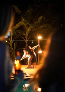 a couple of people dancing on a stage at night at Raindance Hostel in Santa Cruz