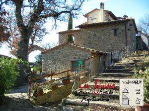 a stone house with stairs leading up to it at La Giuiaia - Agriturismo Azienda Agricola in Ravigliano