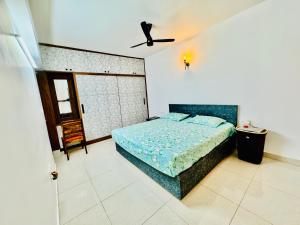 a bedroom with a bed and a ceiling fan at 6Floor in society Ecity ph2 Near TCS Tech Mahindra in Bengaluru