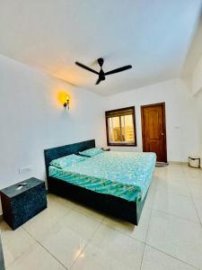 a bedroom with a bed and a ceiling fan at 6Floor in society Ecity ph2 Near TCS Tech Mahindra in Bengaluru