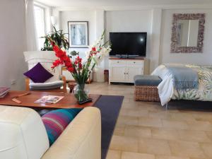 a living room with a couch and a tv at Avalon Horizons in Bilgola