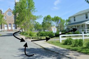 a street sign that reads cite myoke in front of a house at Gite Nycole in Perce