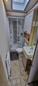 a small bathroom with a toilet and a sink at Ramblers Retreat in Cockermouth