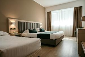 Postel nebo postele na pokoji v ubytování Grand Hotel la Chiusa di Chietri