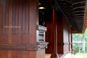 a room with a wooden wall with a wooden organ at Poovar Heritage Homes in Pūvār
