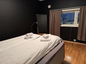 a bedroom with a bed with two towels on it at Apartment close to major attractions in Tromsø