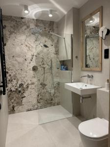 a bathroom with a shower and a sink and a toilet at CzorsztynLakePL in Kluszkowce +22 photos