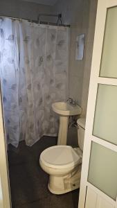 a bathroom with a toilet and a sink at Casa Cachi in Mexico City