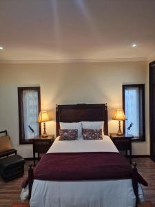 a bedroom with a large bed with two windows at Casa dos Trigais in Marco de Canaveses +28 photos