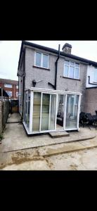 a house with sliding glass doors in front of it at Time Space Bliss in Dagenham Dock