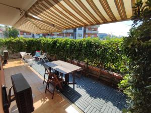 Un patio con una mesa y sillas bajo una sombrilla. en Bignonia garden, en Mascali 8 fotos más