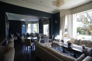 a living room with couches and a dining room at Applewood Hotel in Bournemouth