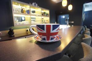a coffee cup sitting on a table in a bar at Applewood Hotel in Bournemouth