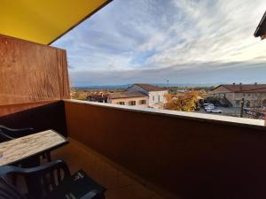 a balcony with a table and a view of a city at Apartmaji Paradiso in Komen