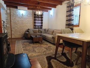 a living room with a couch and a table at Holiday house Ilidza Sarajevo in Crkvine