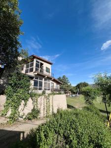 a large house on a hill with bushes in front of it at Montecielo in San Antonio de Arredondo