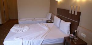 Postel nebo postele na pokoji v ubytování Magic Sun Hotel