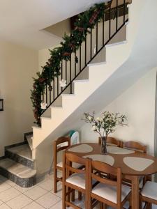 a dining room with a table and chairs and stairs at Madelulu House in Pramanta +25 photos