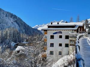 a building with a sign on it in the snow at Alkira in Sankt Anton am Arlberg