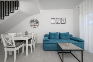 a living room with a blue couch and a table at Roris House in Povljana +39 photos