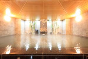 a large room with a pool in the middle of a room at Vessel Hotel Campana Kyoto Gojo in Kyoto