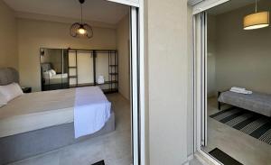 a bedroom with a bed and a sliding glass door at Crystal Private Pool House in Artemida